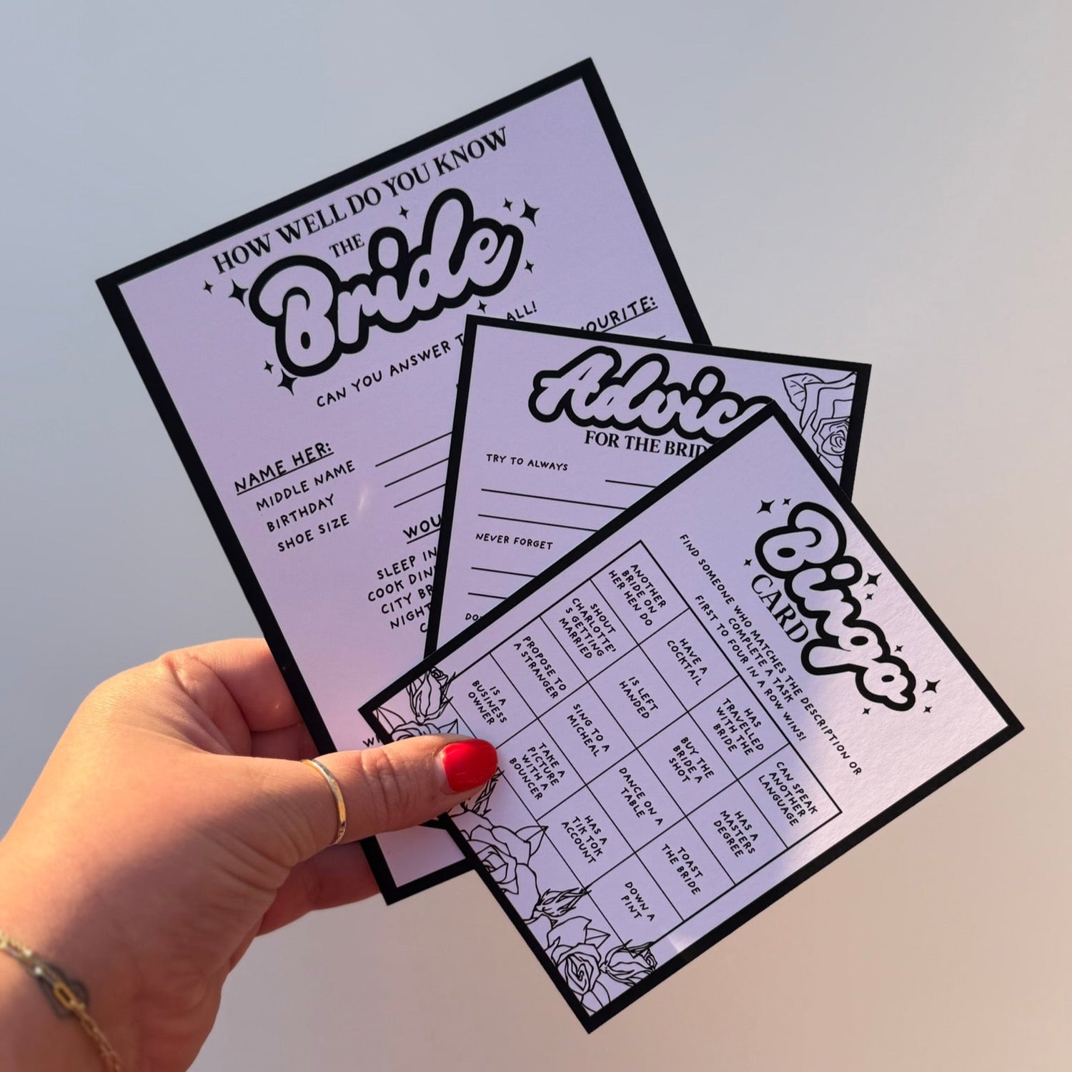 3 black and white hen do activity cards. Including A5 how well do you know the bride cards, a6 advice for the bride card and a6 bingo cards. featuring a rose and sparkle design.